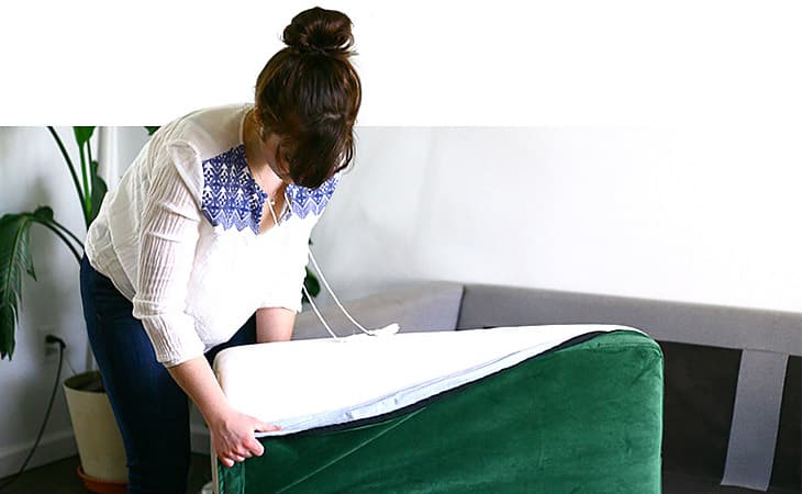 Putting on Comfort Works' custom IKEA Karlstad sofa cushion cover in velvet green (Rouge Emerald)